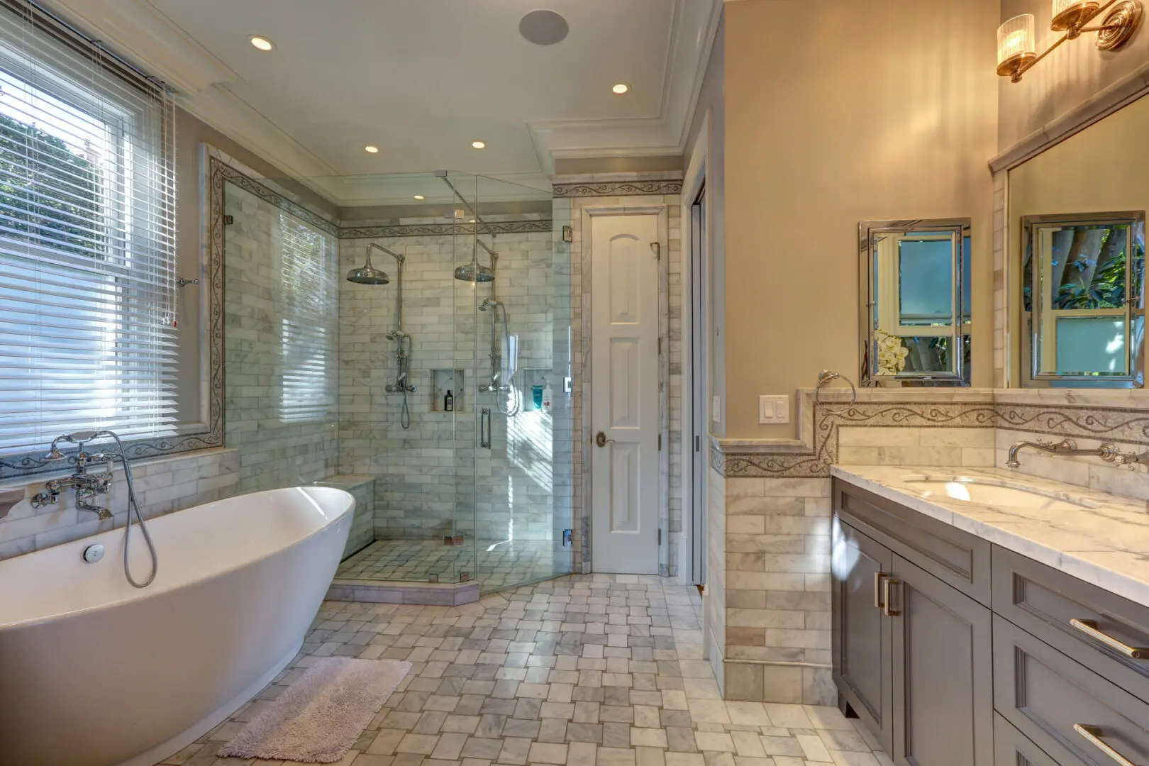 A bathroom with a large walk in shower and a tub.