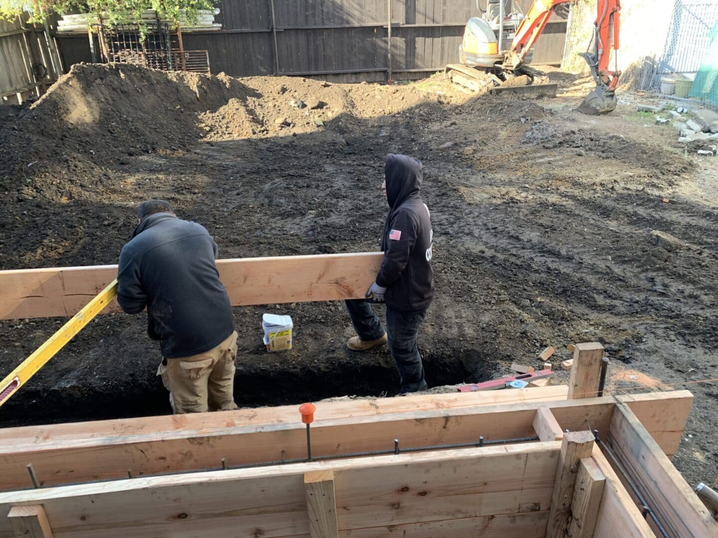 Two men working on a construction site.