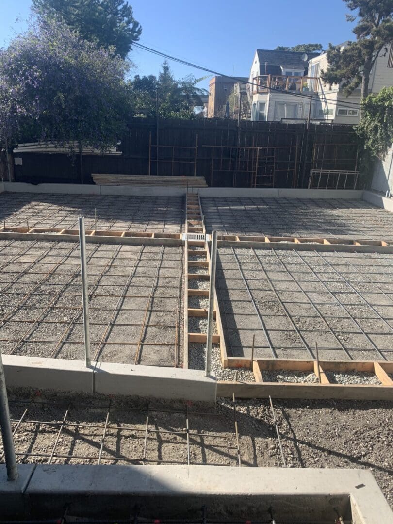 A concrete slab being poured for the foundation of a house.