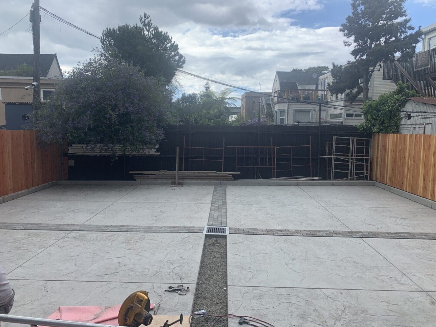 A dog laying on the ground in front of a building.