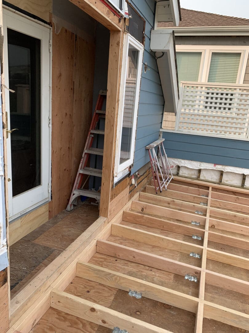 A ladder is in the middle of a porch.