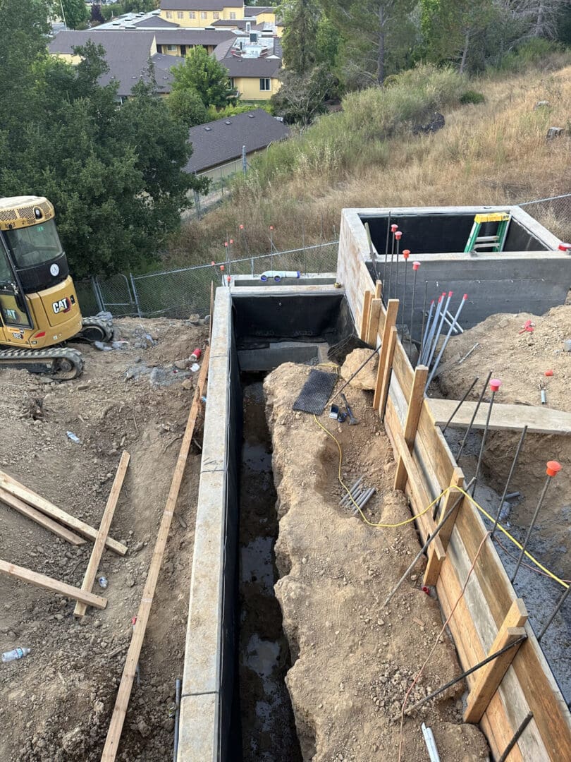 A construction site with a yellow tractor and some dirt