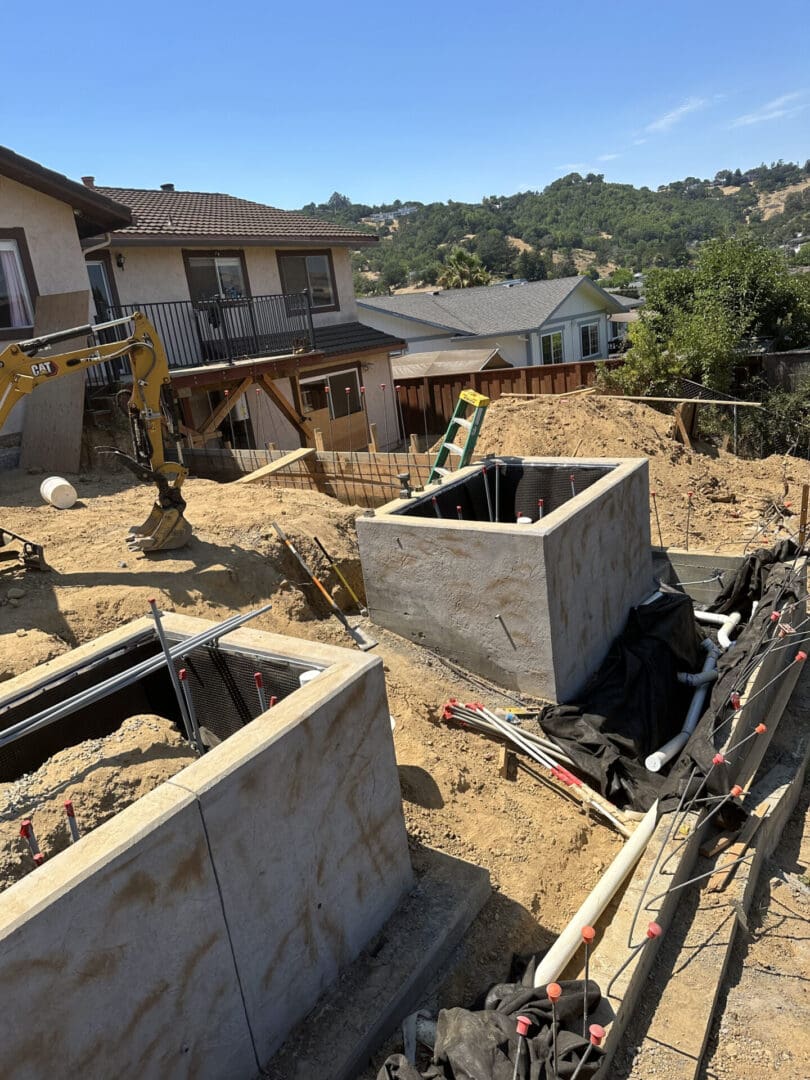 A construction site with a house and some equipment.