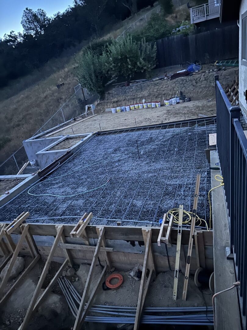 A concrete slab being poured for the foundation of a house.