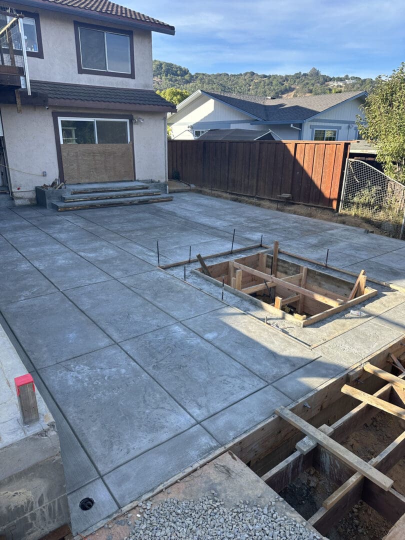 A concrete slab being poured for a patio.