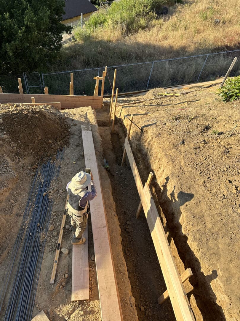 A fire hydrant is being built in the dirt.