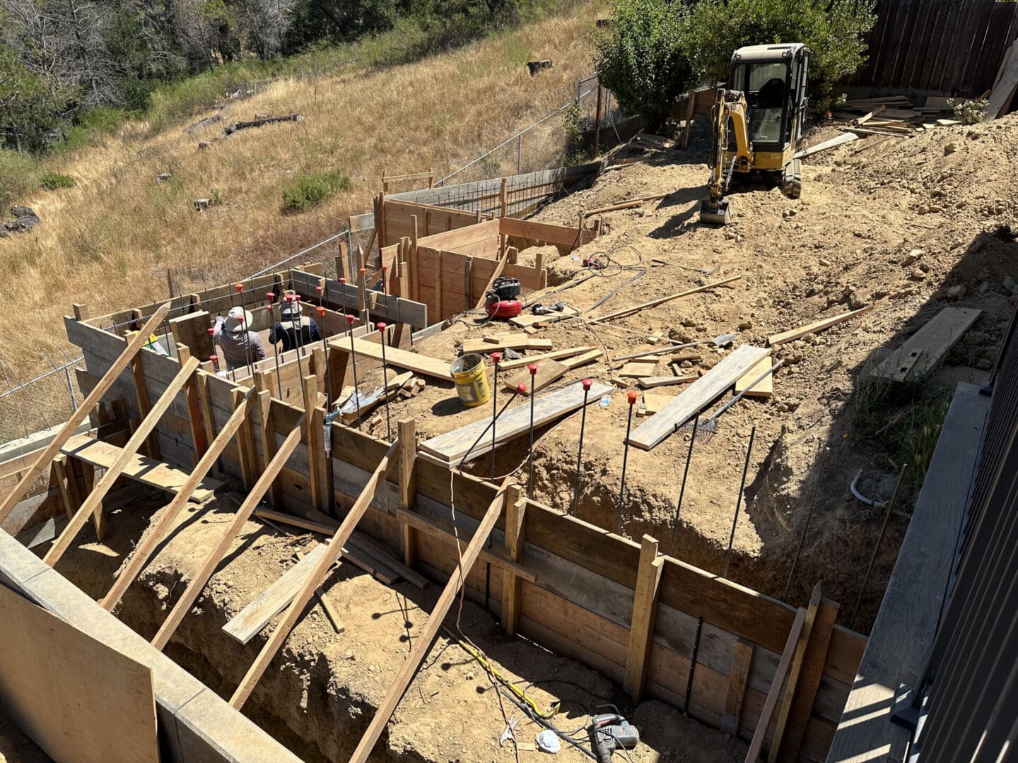 A construction site with workers and equipment on the ground.